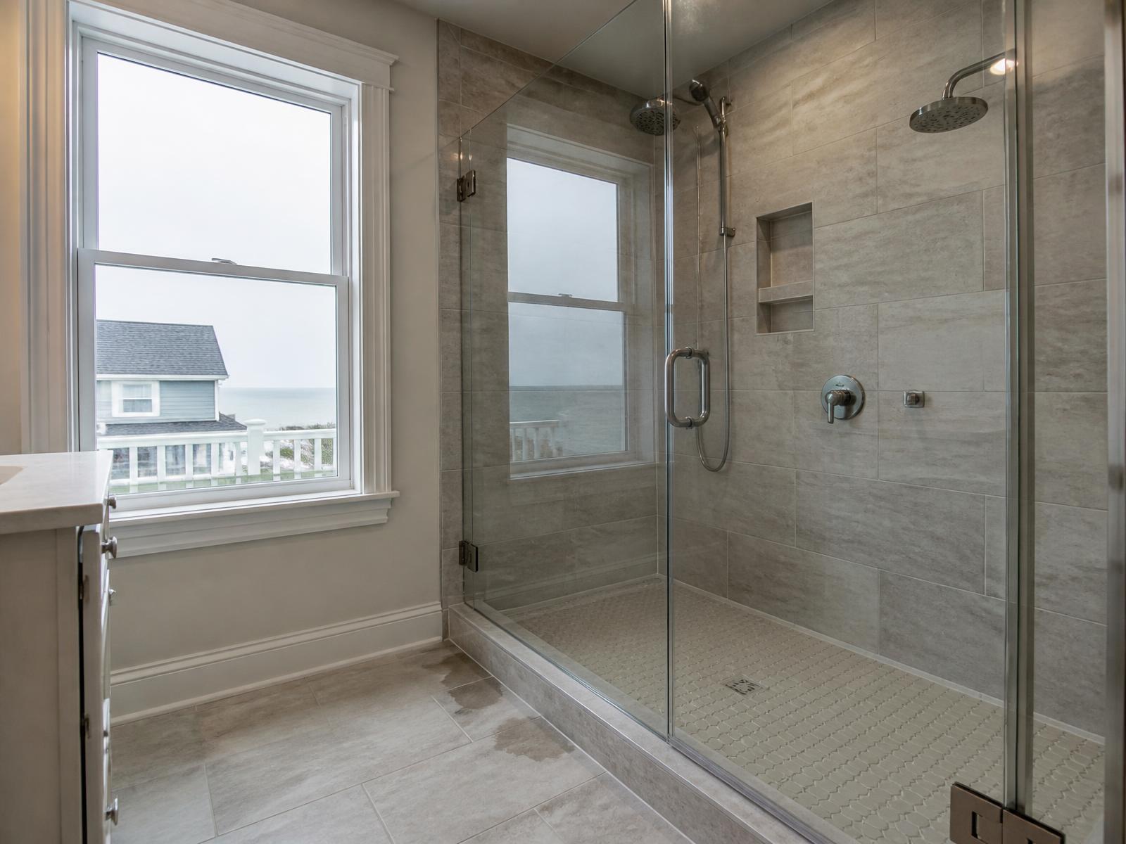 Frameless glass shower enclosure in a coastal New Jersey primary bathroom